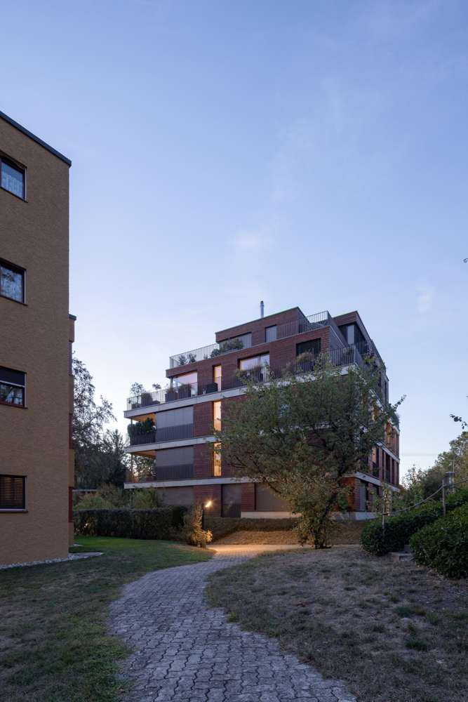 Im Quartier: der Baukörper mit den zurückgestaffelten Attikageschossen zwischen den Nachbarbauten.
